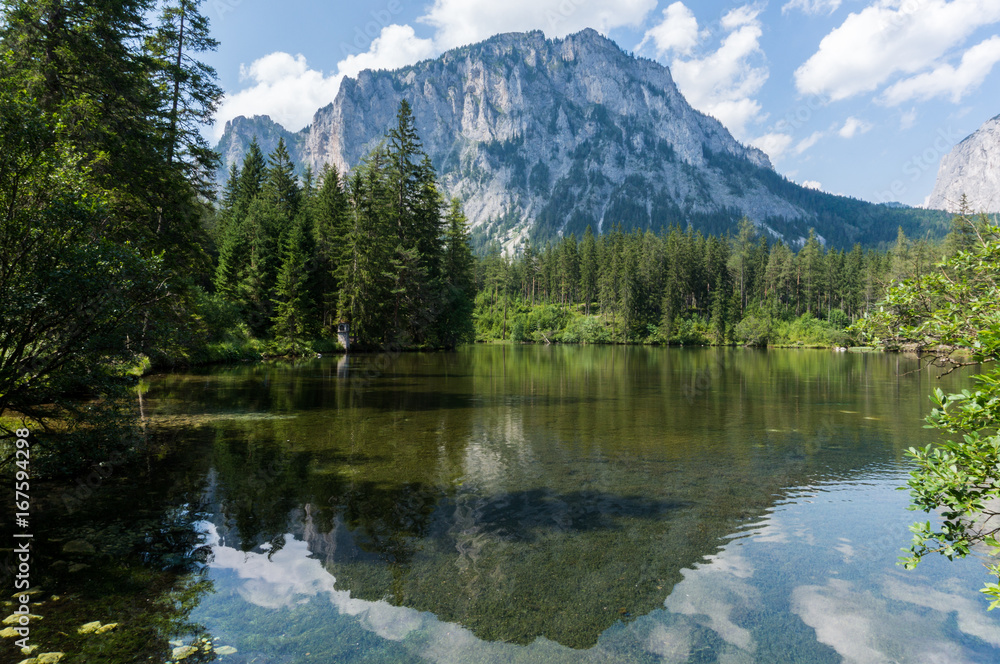 Mountain reflecting in the crystal clear waters of an alpine lake