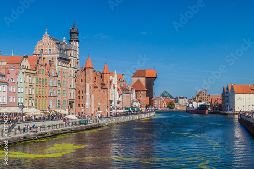 GDANSK, POLAND - SEPTEMBER 1, 2016: Riverside houses by Motlawa river in Gdansk, Poland. Medieval crane in the background.