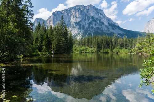 Fototapeta Naklejka Na Ścianę i Meble -  Mountain reflecting in the crystal clear waters of an alpine lake