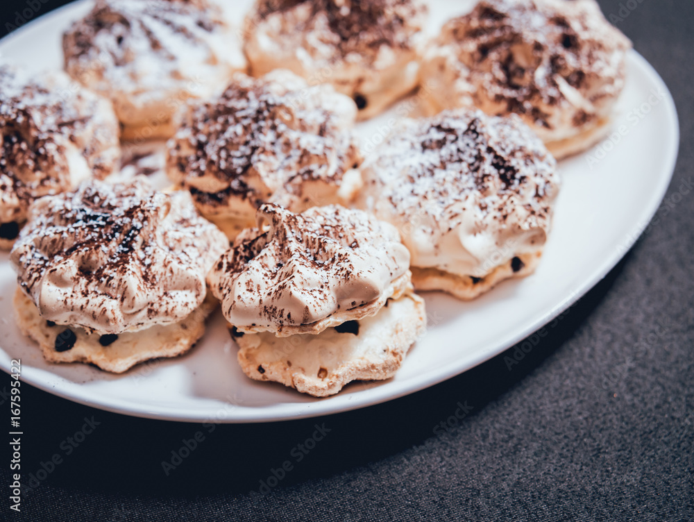 French meringue cookies on the white plate.