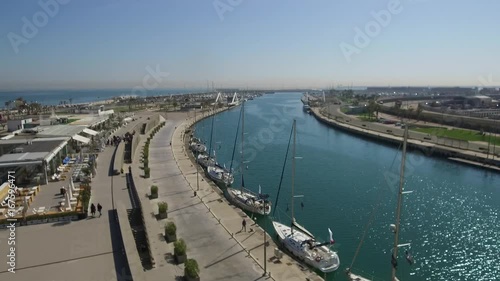 Wallpaper Mural Panning camera through the Marina of valencia in the morning, restaurant, place of leisure near the beach. Group of tourists walking the port. Torontodigital.ca
