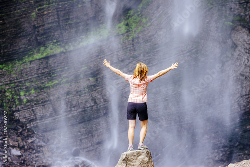 Female tourist enjoys the Gocta waterfall in nothern peru