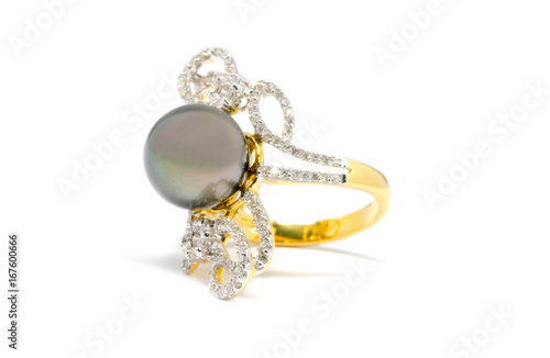 Closed up dark pearl with diamond and gold ring isolated