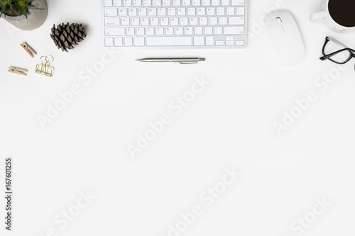 Modern white office desk table with computer gadgets, cup of coffee and office supplies. Top view with copy space, flat lay.