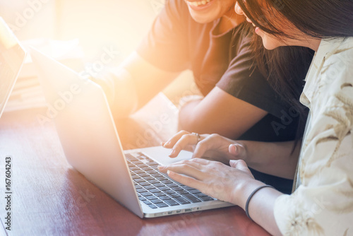 young people being used computer.education, technology and internet concept - two smiling students with laptop.