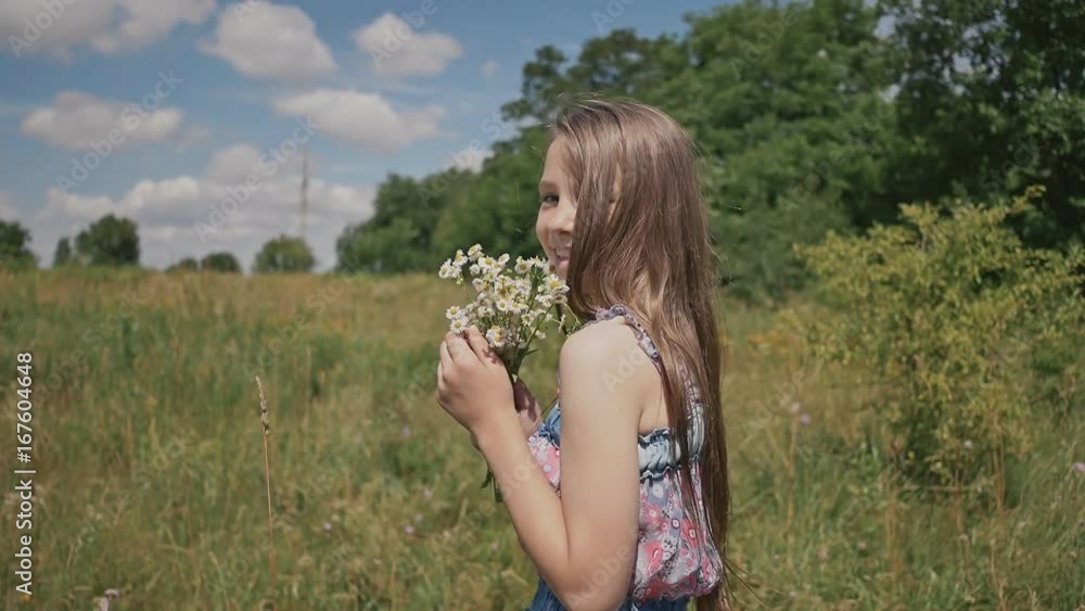 Little girl walk on meadow with with bouquet of flowers chamomile Little girl walk on meadow with with bouquet of flowers chamomile