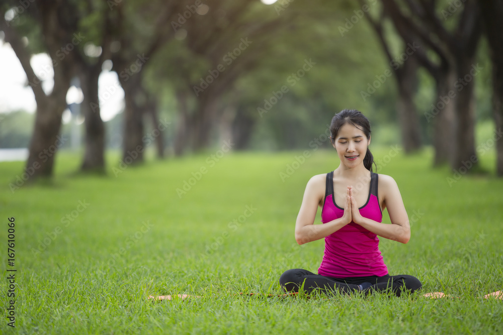 Young woman practicing yoga in park