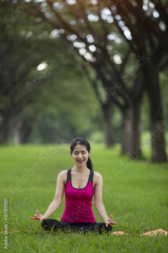 Young woman practicing yoga in park