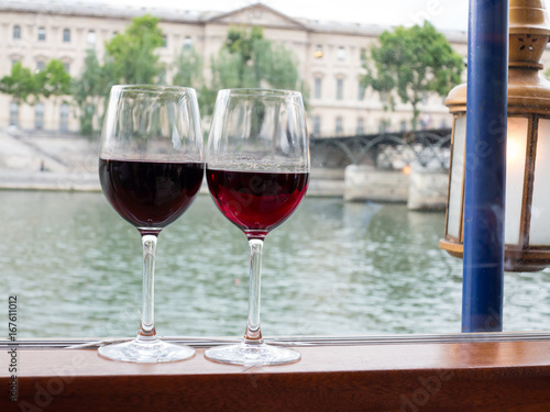 Two glasses of wine on the Seine River in Paris