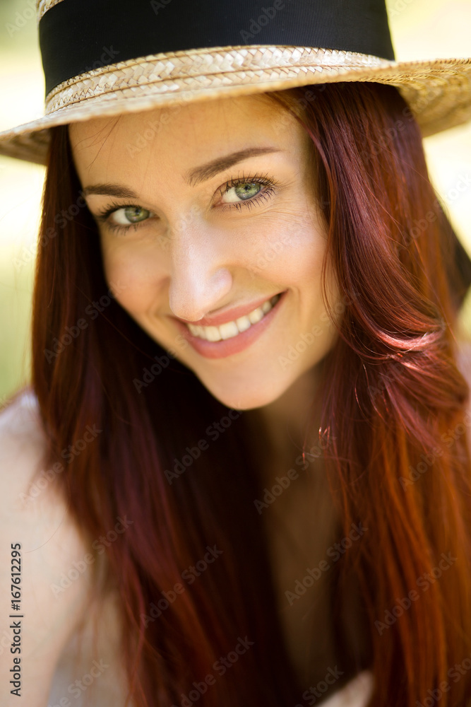 Close up portrait of sexy young lady in straw hat. Foxy woman with blue eyes happily smiling looking at camera. Toned image. Close up portrait of sexy young lady in straw hat. Foxy woman with blue eyes happily smiling looking at camera. Toned image.