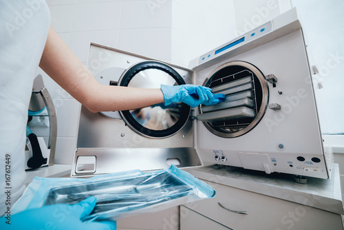 Sterilizing medical instruments in autoclave photo