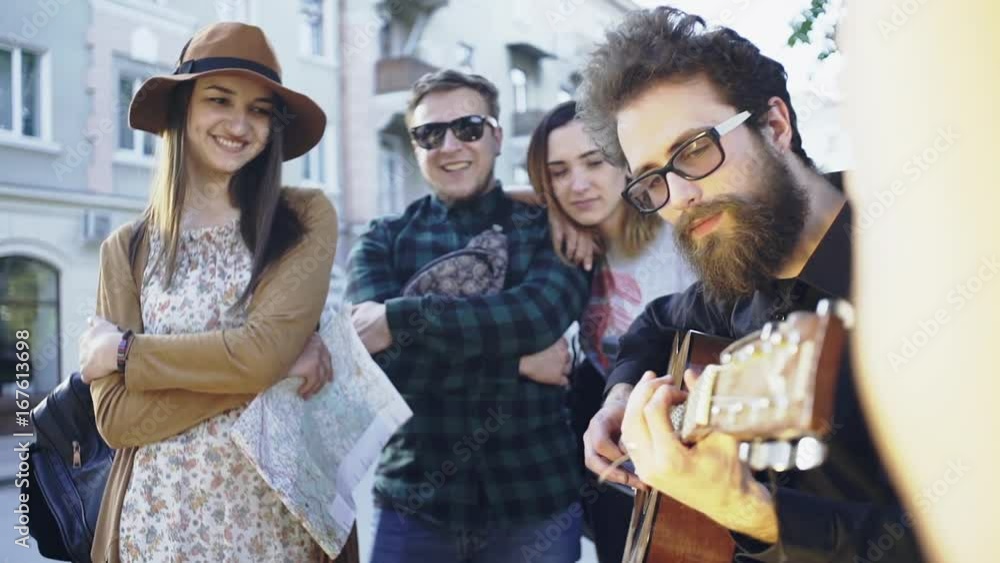 Tourists looking at street musician - slow motion Tourists looking at street musician - slow motion