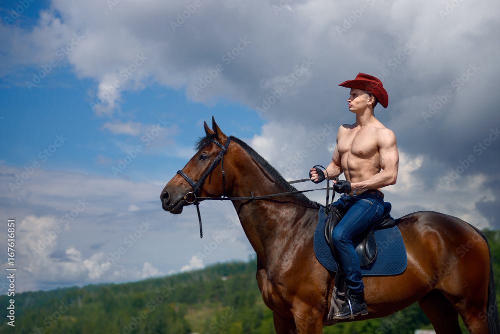 Macho man handsome cowboy and horse on the background of sky and water. Macho man handsome cowboy and horse on the background of sky and water.