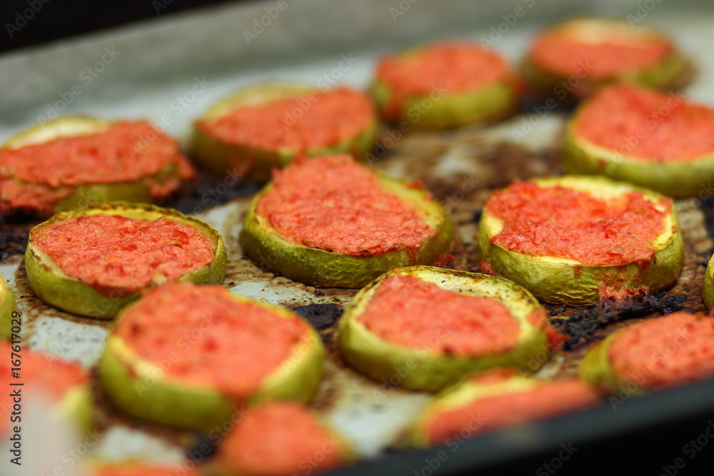 Sliced zucchini in tomato cooked in oven Sliced zucchini in tomato cooked in oven