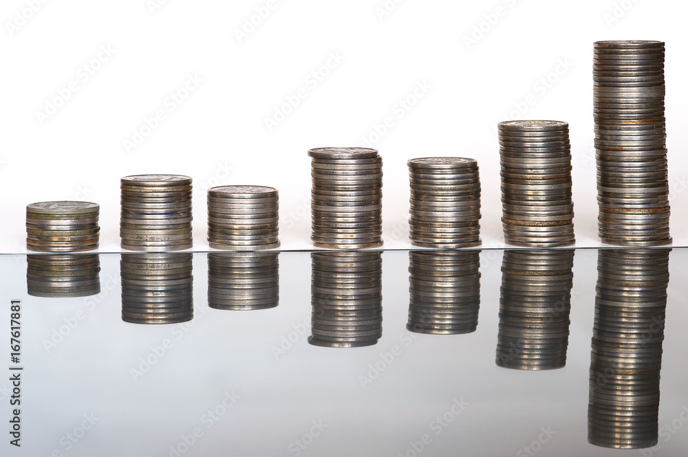 Piles of coins of different height with reflection Piles of coins of different height with reflection