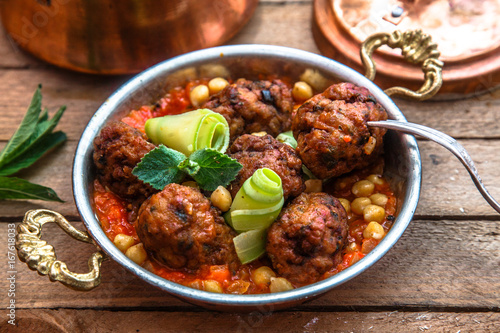 izmir kofte - Turkish traditional meatball with chickpeas. tomato sauce and mint