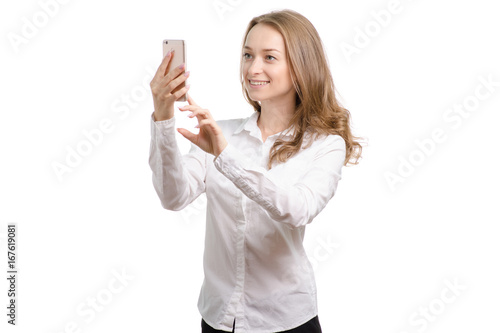 Young woman in a white shirt with a smartphone