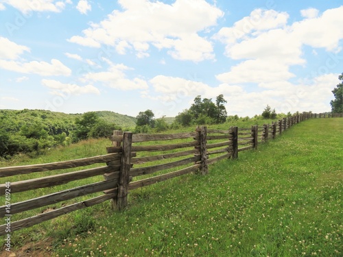 Wooden fence  along a pasture in the mountains