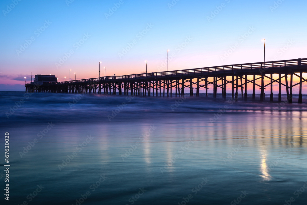 View of pier on sea during sunset