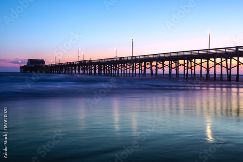 View of pier on sea during sunset