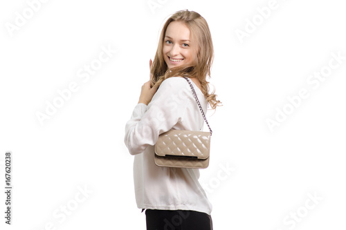 Beautiful girl with a lacquer bag on her shoulder