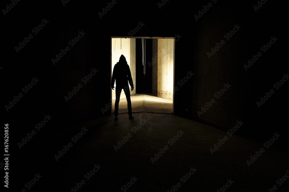 Silhouette of hooded person