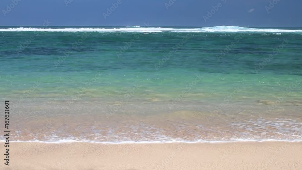 Tropical beach in sunny day. Beautiful sky and ocean, paradise place, secret beach. Bali island, Indonesia. Tropical beach in sunny day. Beautiful sky and ocean, paradise place, secret beach. Bali island, Indonesia.
