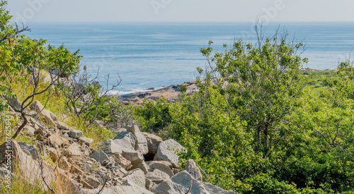 steep, rocky, green hillside overlooking the Atlantic ocean at Cape Ann, Massachusetts