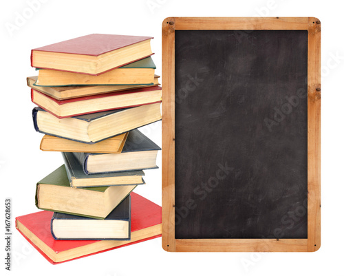 Stack of books with school blackboard