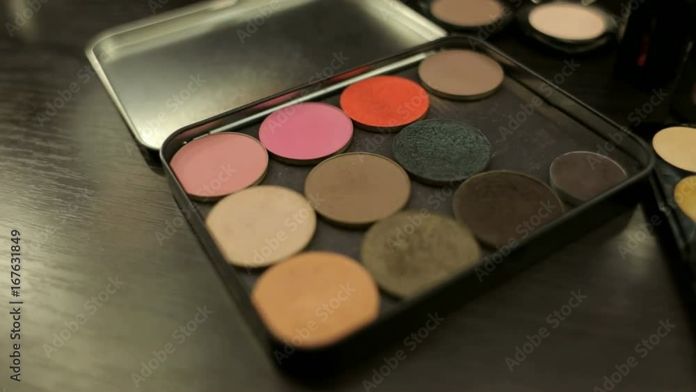 Professional eyeshadow palette eye close-up on the table. Close-up of a palette of eye shadow on the table. Professional eyeshadow palette eye close-up on the table. Close-up of a palette of eye shadow on the table.