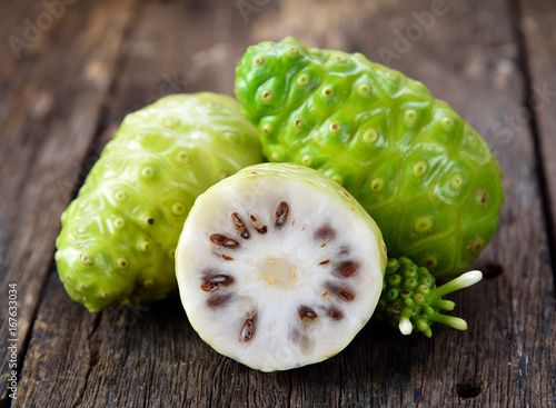 noni fruit on wooden background
