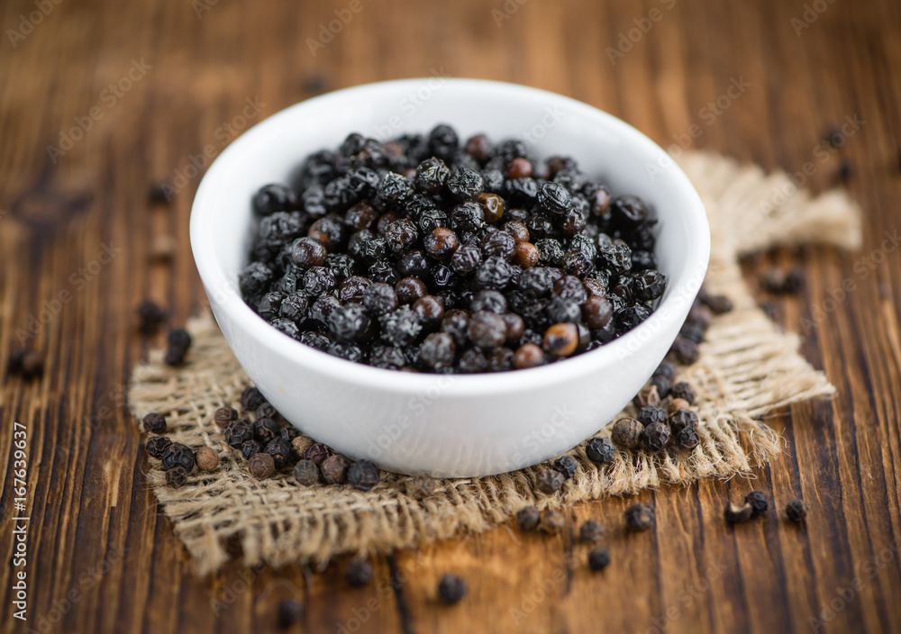 Wooden table with preserved black Peppercorns Wooden table with preserved black Peppercorns