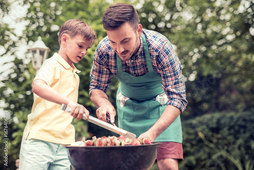 Father and son having a barbecue party