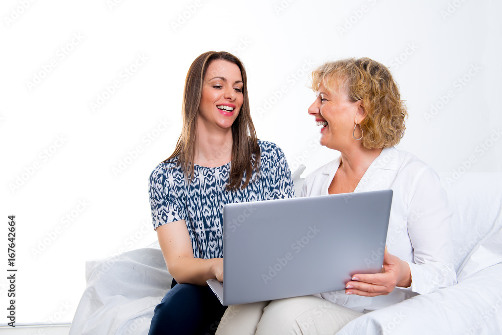 young woman and her mother with laptop young woman and her mother with laptop