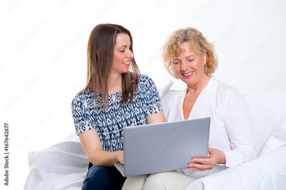young woman and her mother with laptop young woman and her mother with laptop