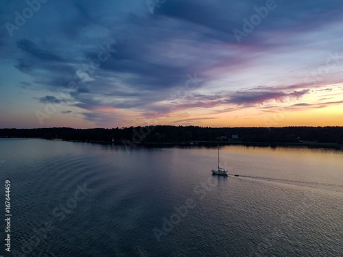 Sunset at archipelago of sweden with small boat