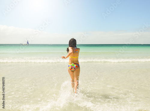 Young asian woman runing at beach