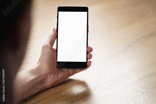 young man hand holding smartphone with blank white screen