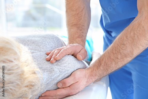 Physiotherapist working with patient in clinic