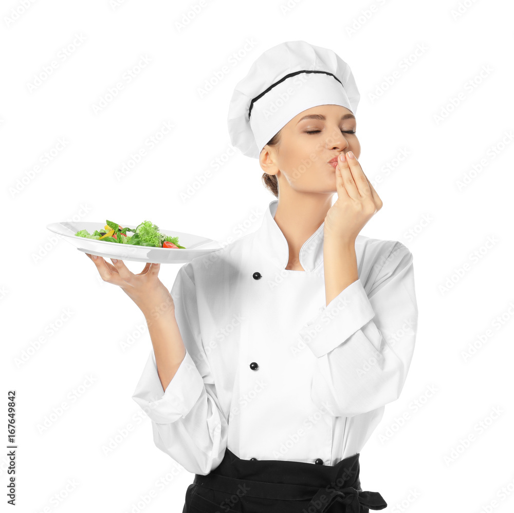 Young female chef holding plate with salad on white background Young female chef holding plate with salad on white background