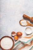Ingredients for baking  - flour, wooden spoon, eggs.