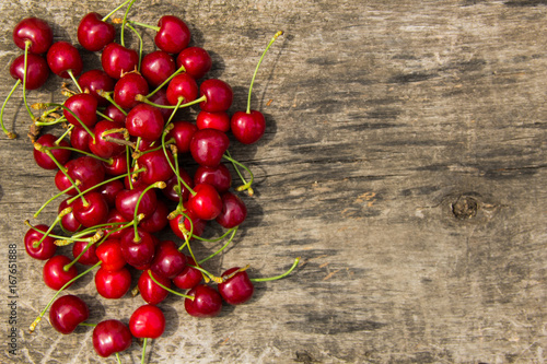 Red cherry fruits on wooden background