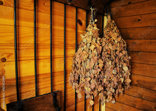 Quadro em tela Birch brooms for a bathhouse on a wooden wall