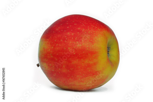 Red-yellow apple lies on its side on a white background