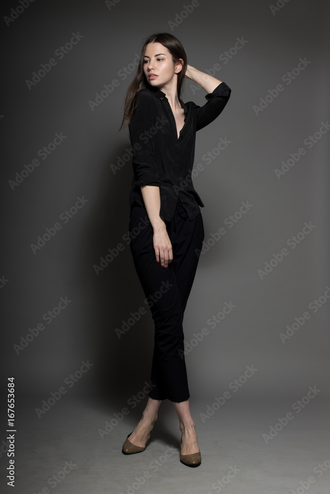 European attractive sexy fashion model with natural brunette hair, posing in studio, wearing black shirt, dark background, beauty photo shot, retouched image European attractive sexy fashion model with natural brunette hair, posing in studio, wearing black shirt, dark background, beauty photo shot, retouched image