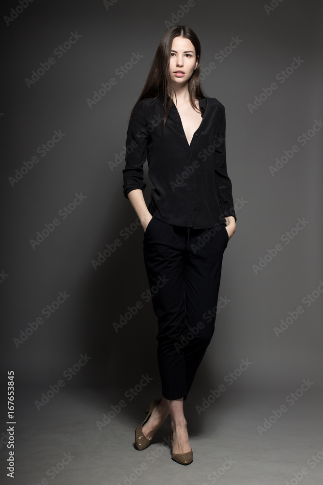 European attractive sexy fashion model with natural brunette hair, posing in studio, wearing black shirt, dark background, beauty photo shot, retouched image European attractive sexy fashion model with natural brunette hair, posing in studio, wearing black shirt, dark background, beauty photo shot, retouched image