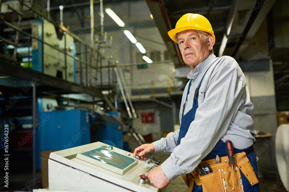 Senior Man Operating Machine Units at Factory Senior Man Operating Machine Units at Factory