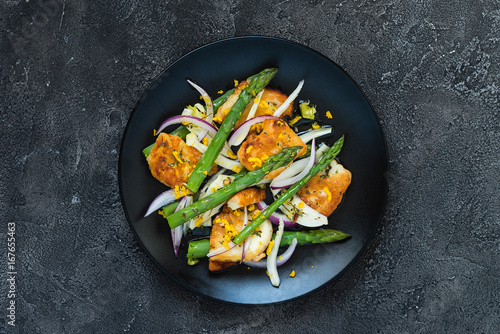 Salad with fried halloumi, asparagus and orange zest. Top view, copy space