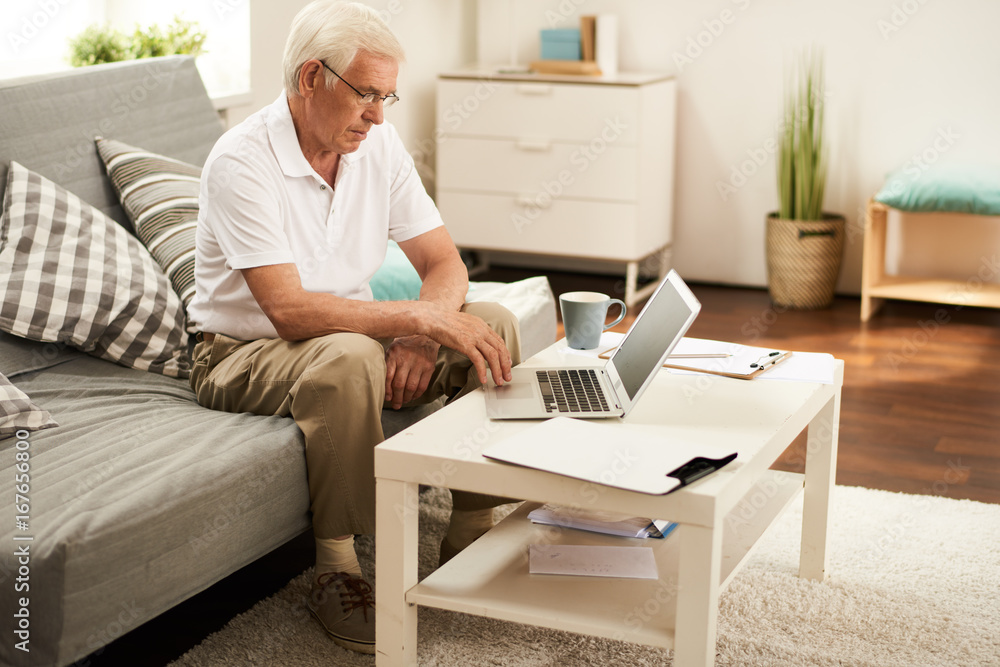 Senior Man Working with Laptop at Home Senior Man Working with Laptop at Home