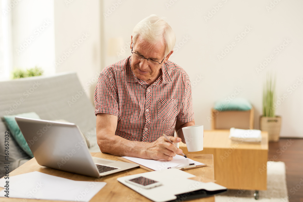 Senior Man Counting Taxes at Home Senior Man Counting Taxes at Home